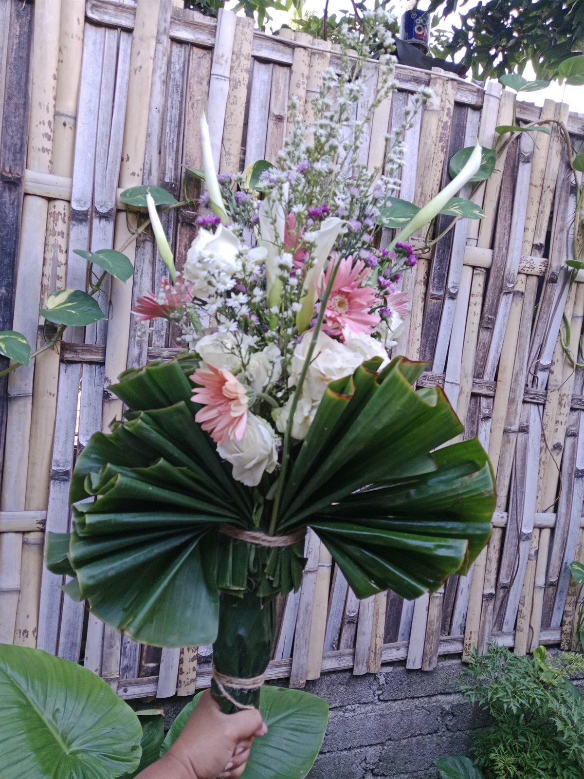 Island Bloom bouquet wrapped with natural leaves