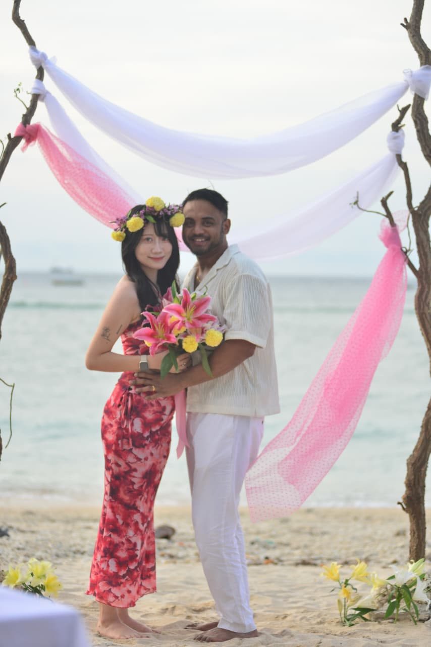 Beach couple with flowers