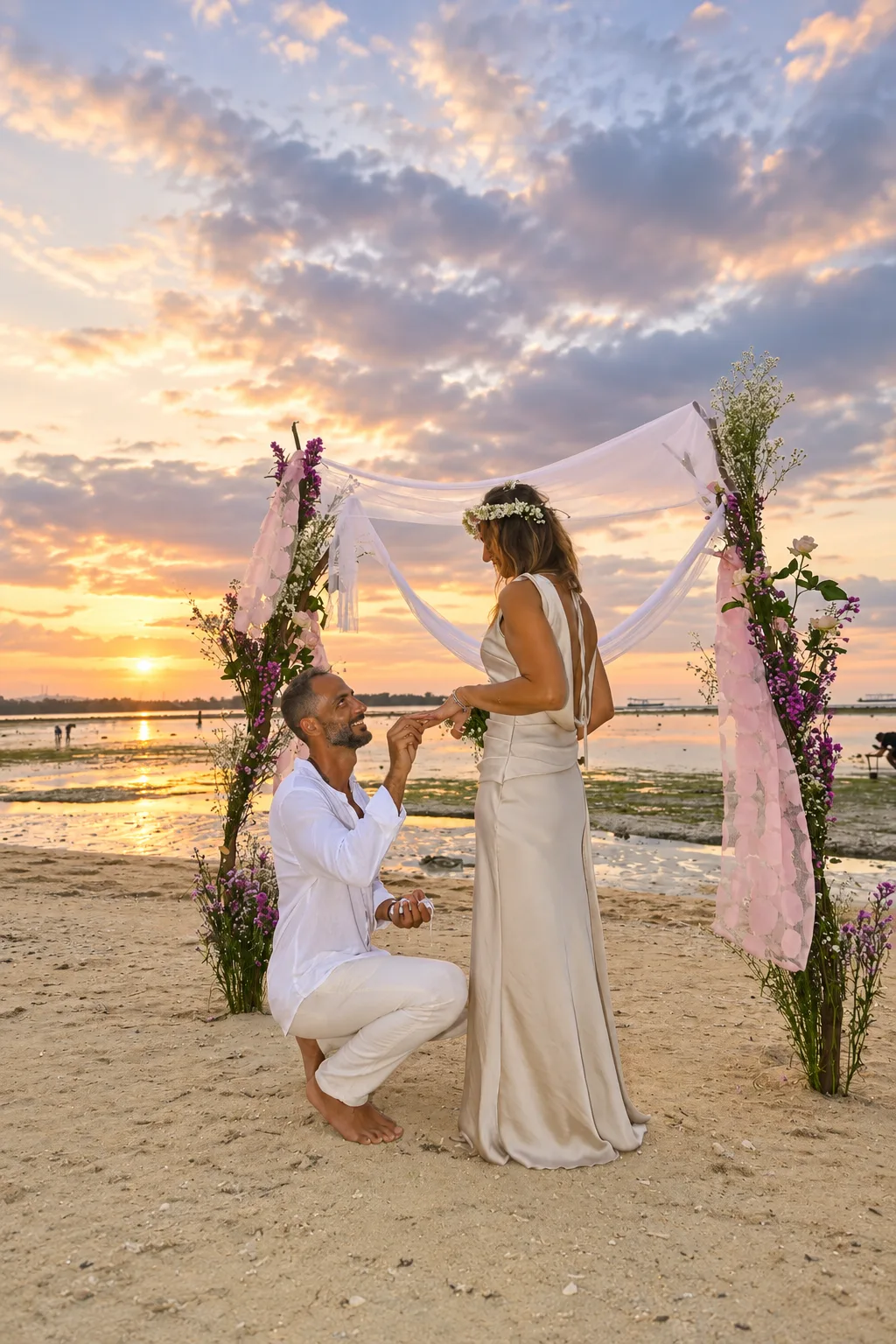 Proposal beneath a floral arch at sunset